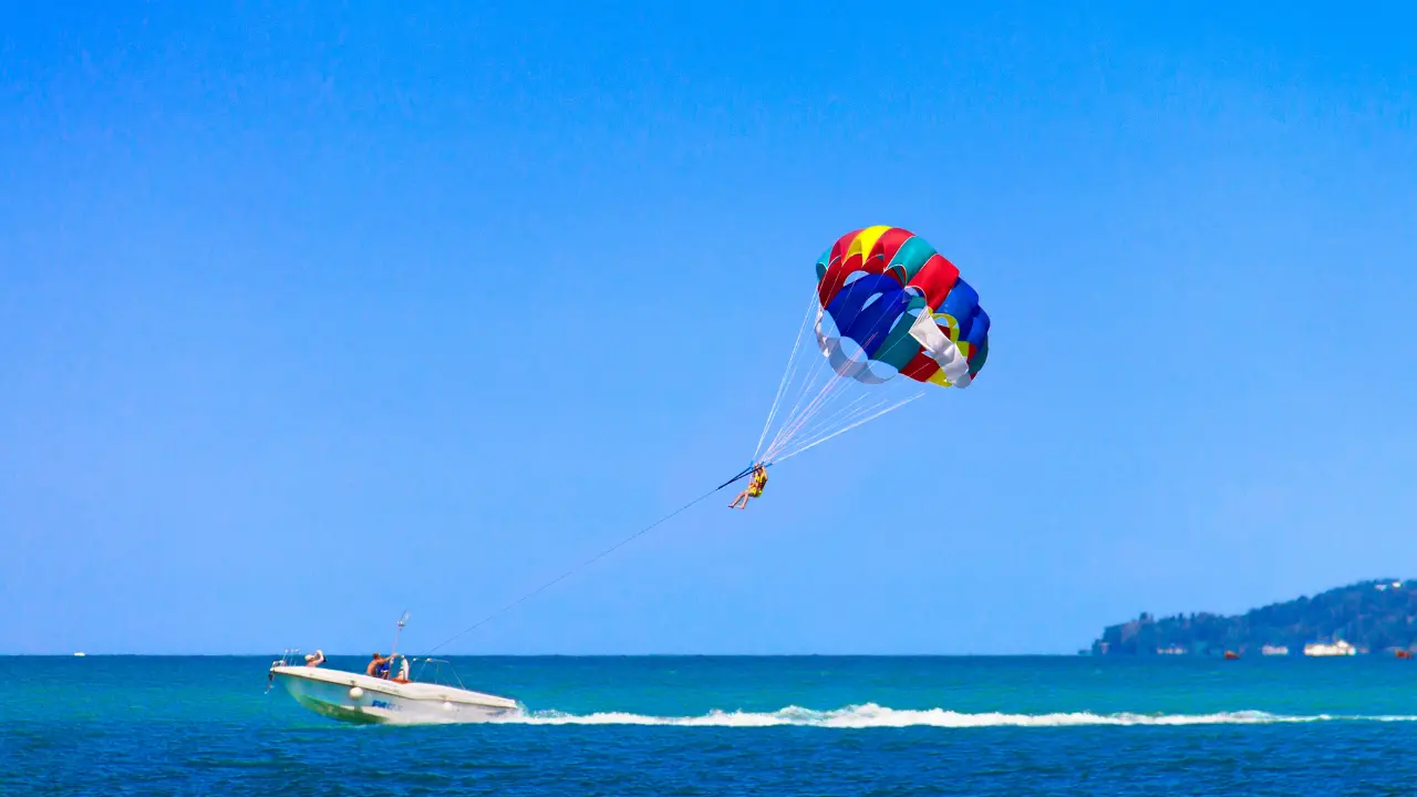 Tourist enjoying parasailing over the blue waters of Andaman Islands