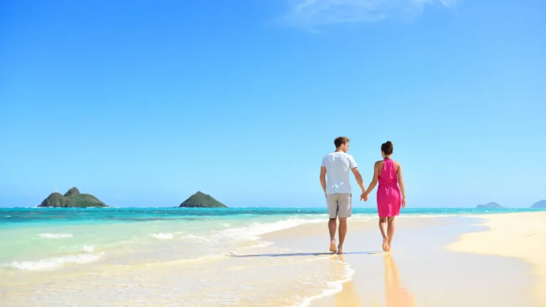 Couple on an Andaman honeymoon trip watching sunset on a serene beach