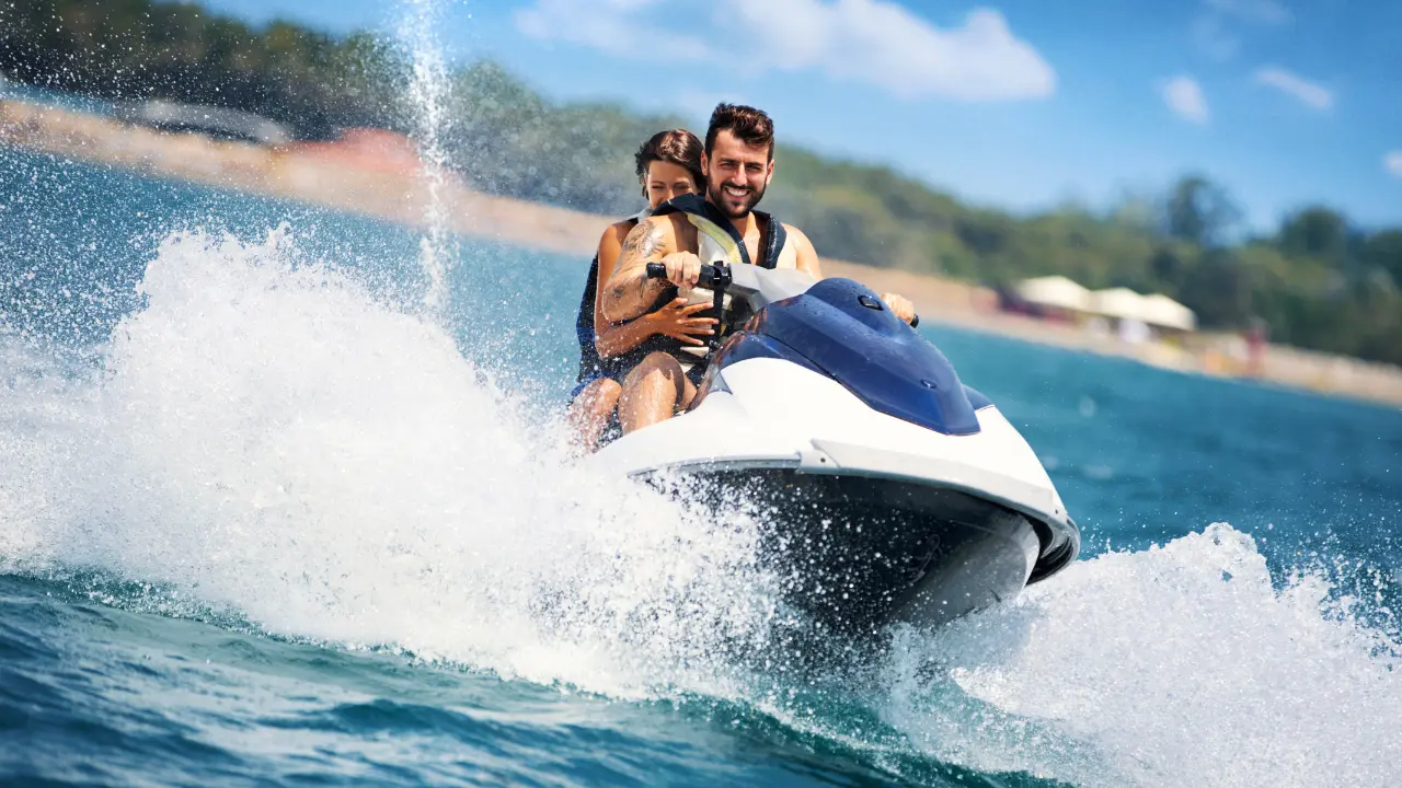 Tourist riding a jet ski on the sparkling blue waters of Andaman Islands