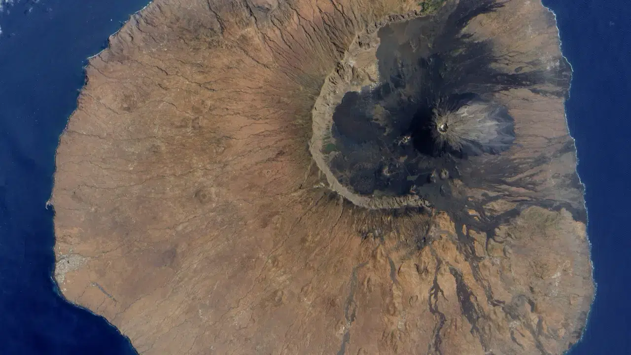Satellite view of Barren Island showing the volcanic crater and rugged lava terrain