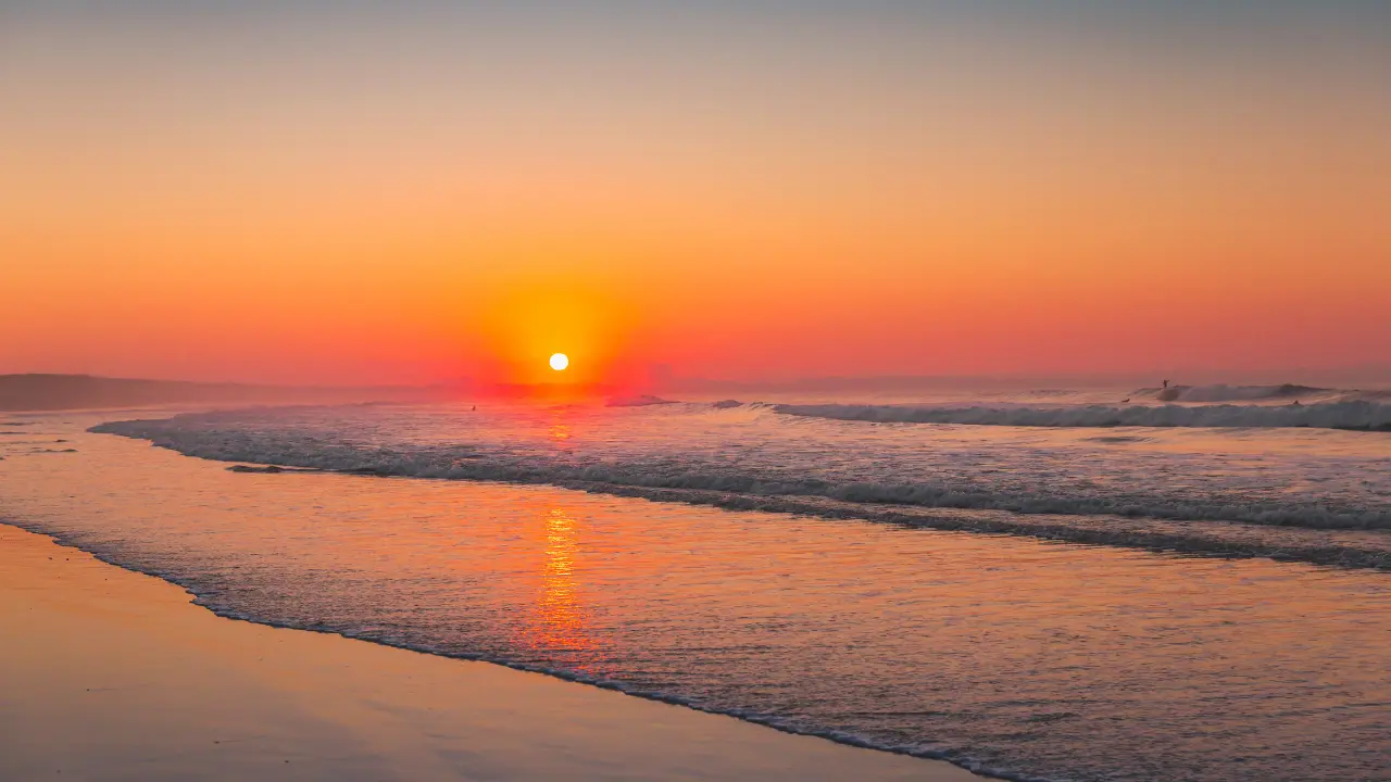 Golden sunrise at Kalapathar Beach reflecting on the waves