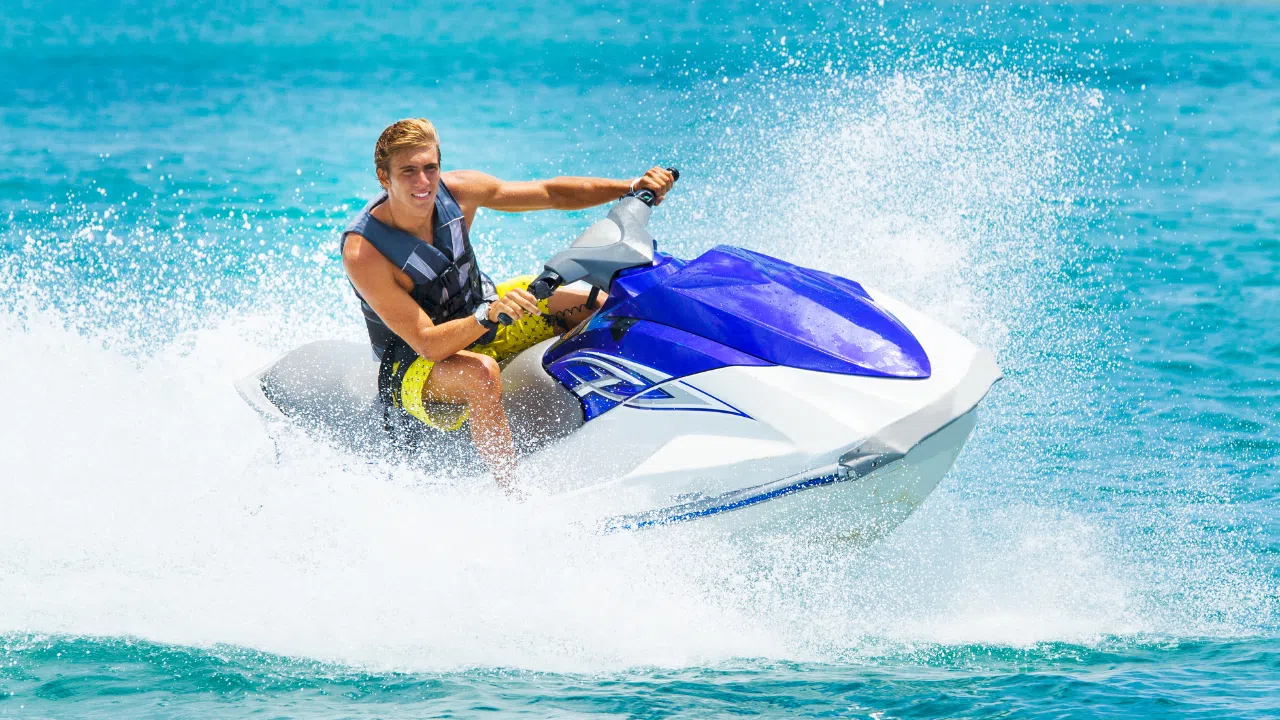 Jet skiing at Elephant Beach with turquoise waters and tropical backdrop